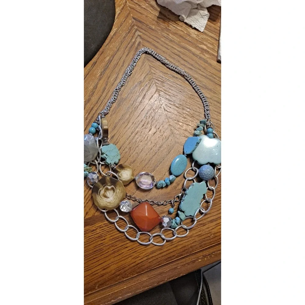 Southwestern-style statement piece featuring multiple strands of silver-toned...